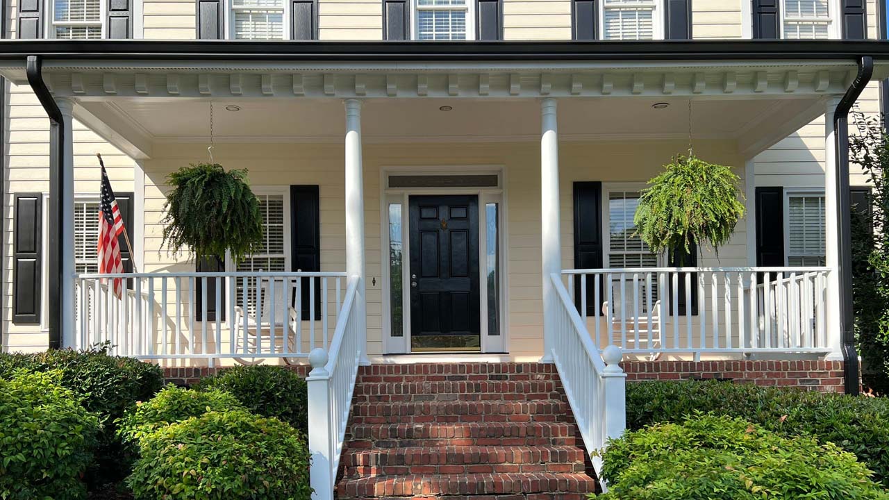 Curb view of an exterior painting project by Triangle Pro Painting. The homeowner worked closely with the team to choose colors that would bring their vision to life.