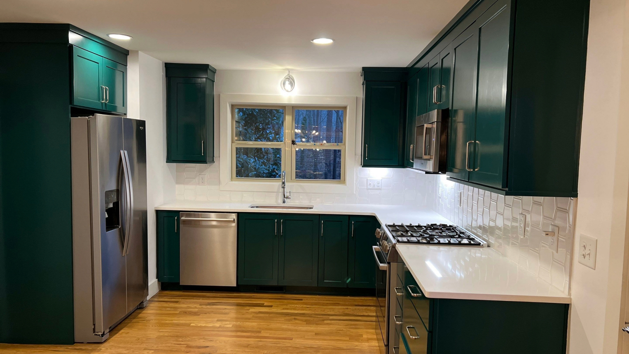 A newly painted kitchen cabinet. The paint used is black color making the kitchen more beautiful and elegant.