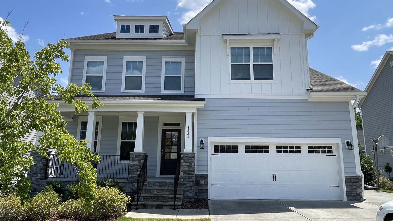 Image of a home that has been repainted. Blue grey and white exterior painting details.