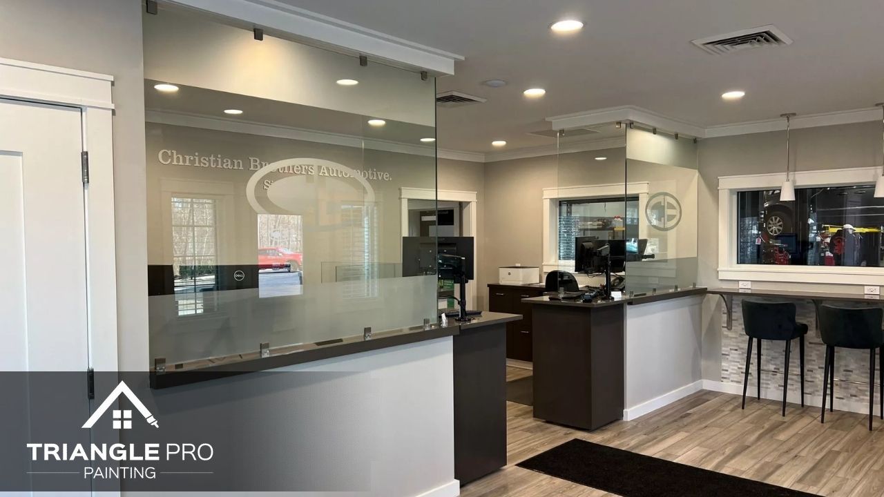 Homeowner painting an interior room with low VOC paint in Raleigh