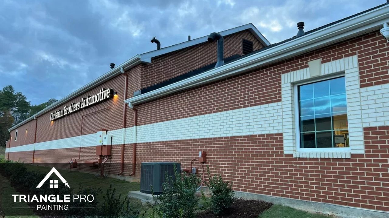 This is a commercial exterior painting project for a brick automotive business by Triangle Pro Painting.