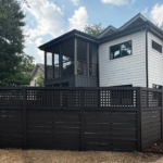A house with a professionally painted fence that reflects Raleigh’s local style and trend, completed by an exterior painting specialist.