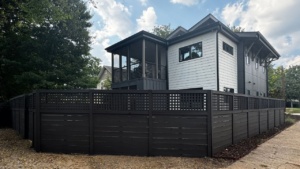 A house with a professionally painted fence that reflects Raleigh’s local style and trend, completed by an exterior painting specialist.
