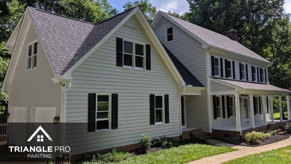 A beautiful exterior residential painting project by Triangle Pro Painting – fresh siding, dark shutters, and crisp white trim for standout curb appeal.