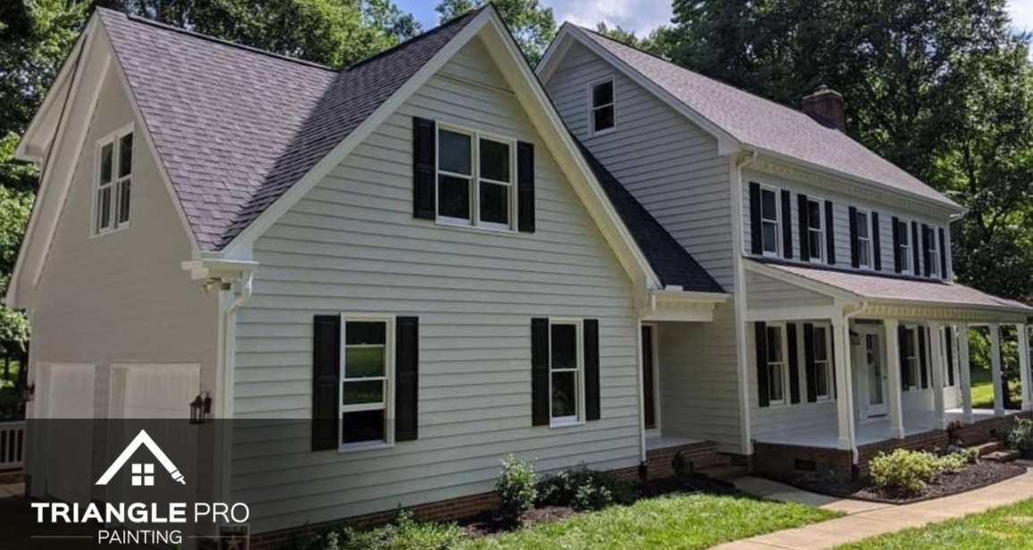 A beautiful exterior residential painting project by Triangle Pro Painting – fresh siding, dark shutters, and crisp white trim for standout curb appeal.