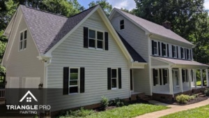A beautiful exterior residential painting project by Triangle Pro Painting – fresh siding, dark shutters, and crisp white trim for standout curb appeal.