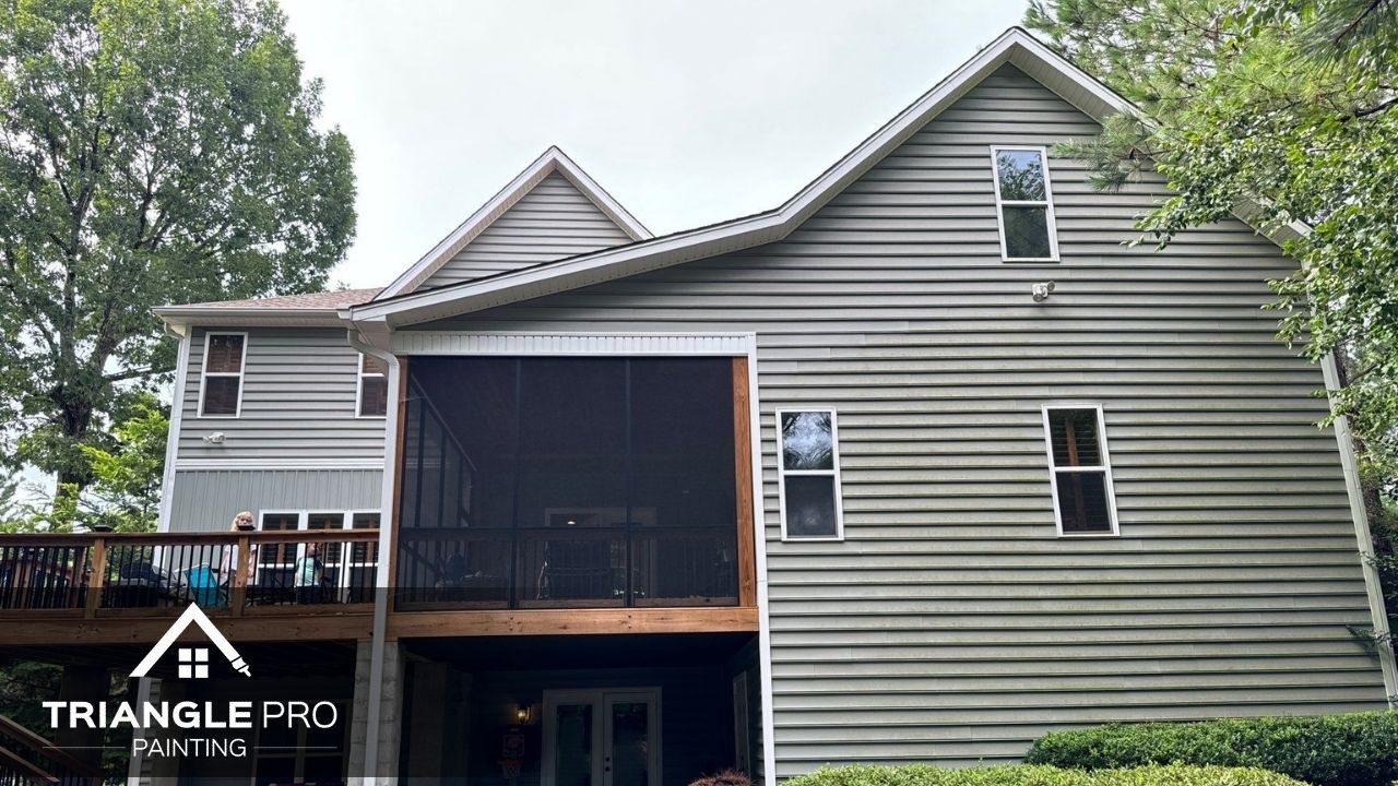 This image displays a full view of a painted exterior house with gray siding by Triangle Pro Painting in Madonna Acres Raleigh NC.