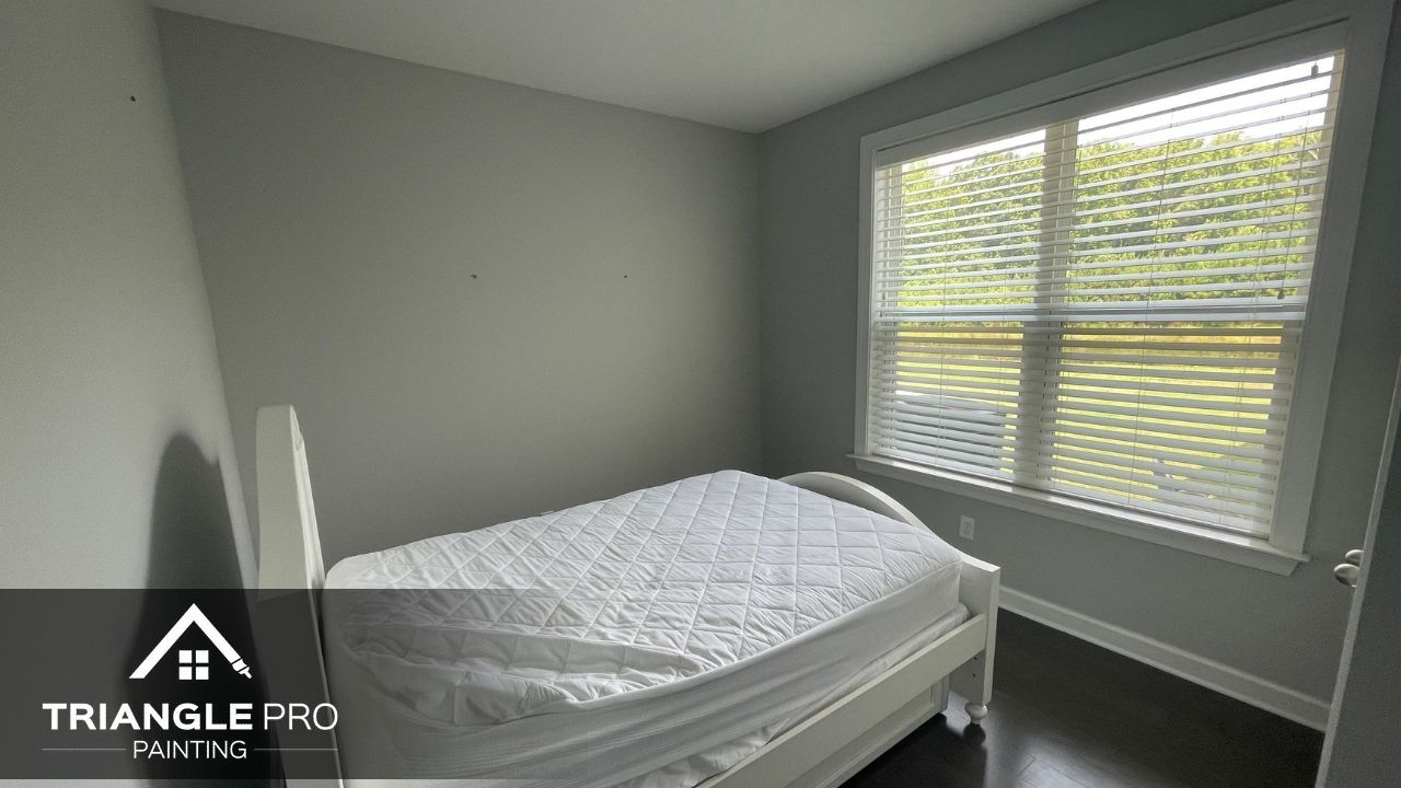 This image shows a bedroom with fresh interior paint by Triangle Pro Painting in Madonna Acres, Raleigh, NC.