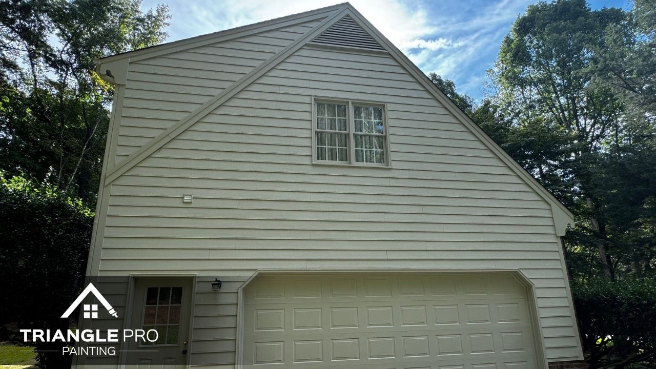 This photo shows a cleanly painted garage wall and trim in a light tone, part of an exterior repaint by Triangle Pro Painting in Madonna Acres Raleigh NC.