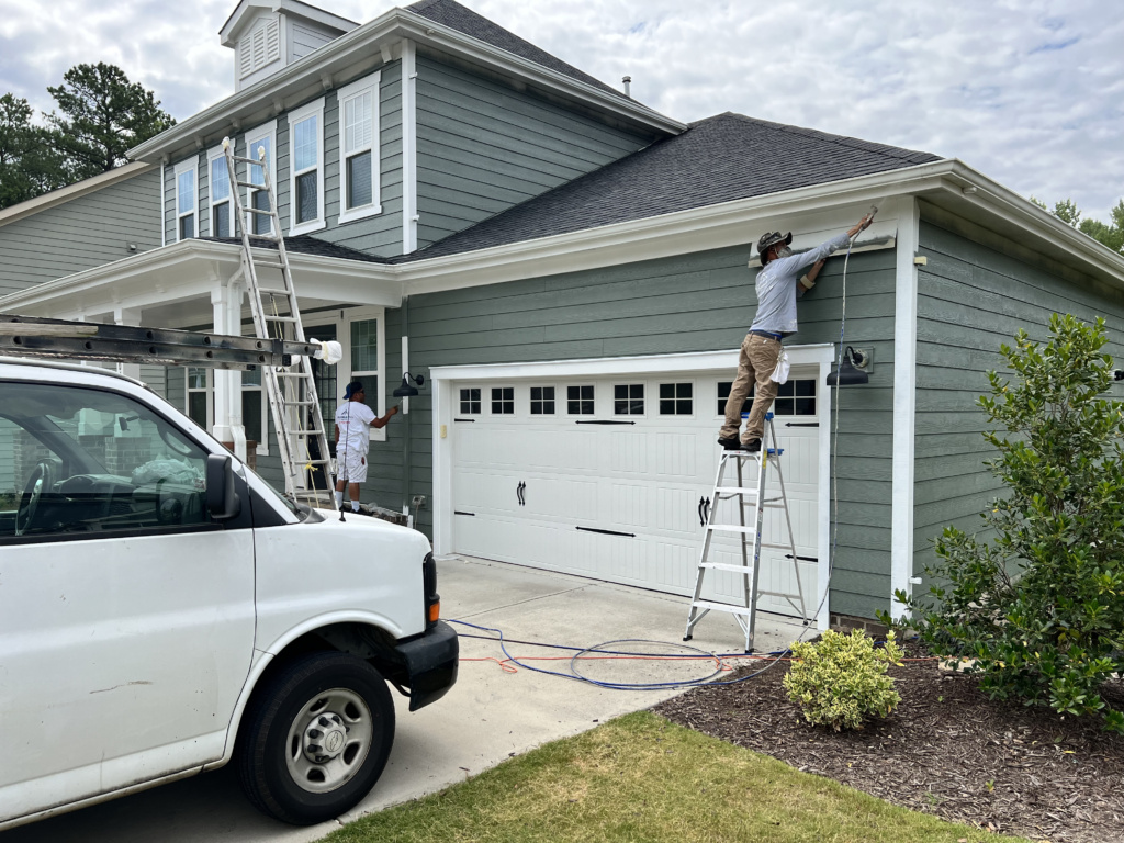 Expert siding painting near me protecting homes from weather damage by Triangle Pro Painting
