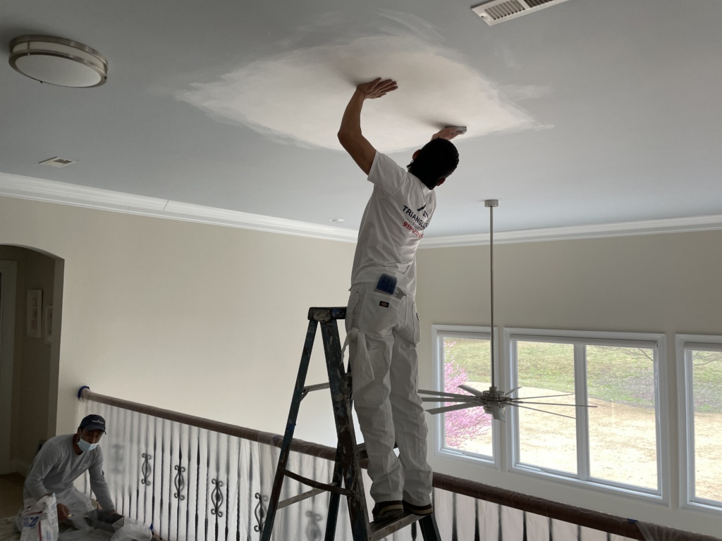 Professional residential painter in Youngsville, NC refreshing interior walls and trim with crisp finishes