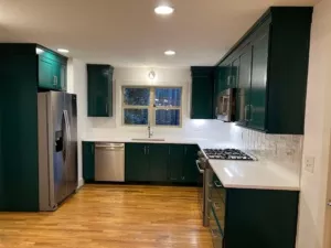 A newly painted kitchen cabinet. The paint used is black color making the kitchen more beautiful and elegant.