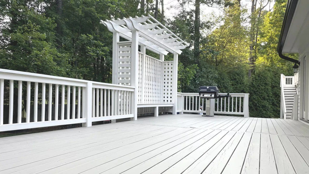 A deck that is newly painted with white paint.