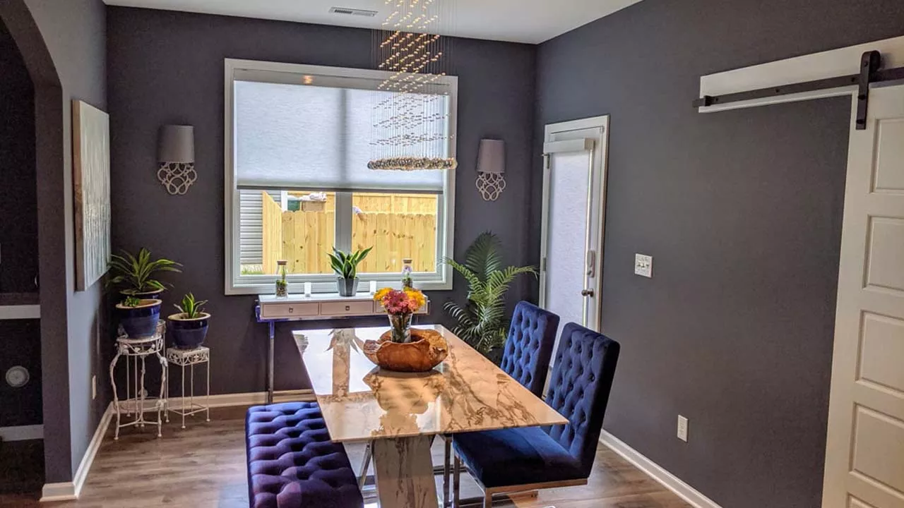 Dining room area that has been repainted with dark grey walls and bright trim