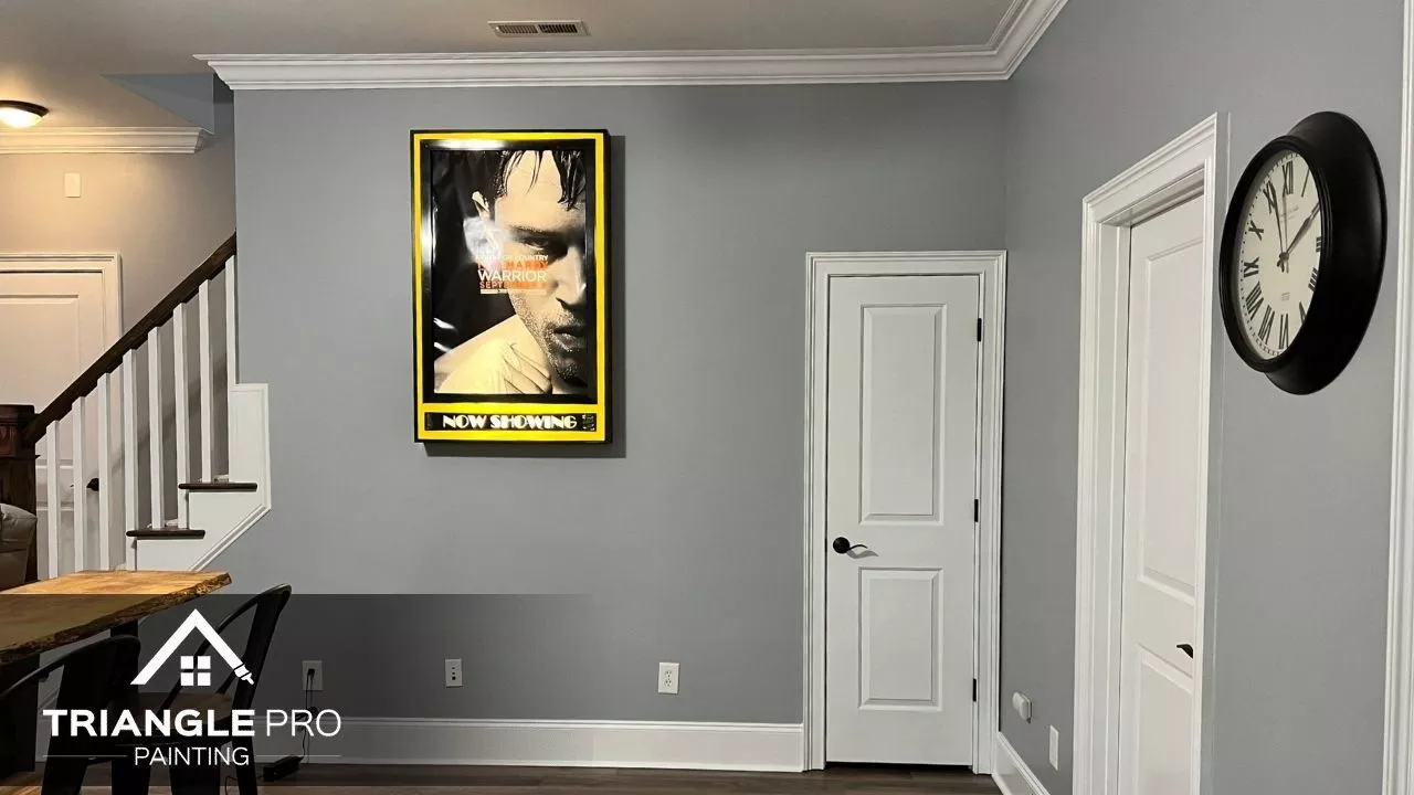 A room painted in soft gray with bright white trim for a sleek, finished feel.