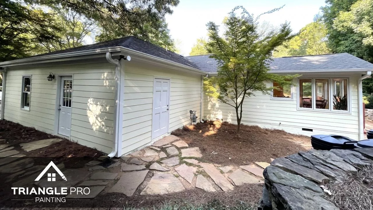 This is an exterior repaint of a detached home structure with light cream siding by Triangle Pro Painting in Umstead Raleigh NC.