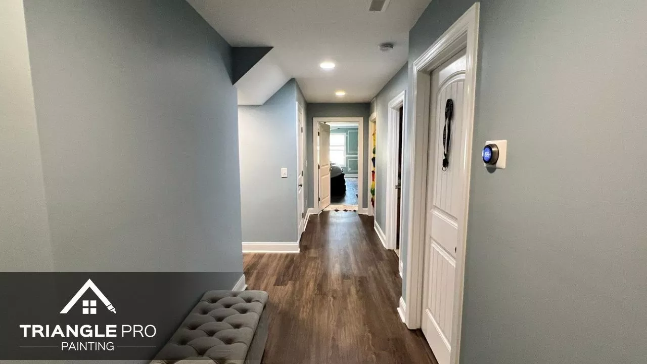 A hallway with light blue walls and white trim, freshly painted for a clean, modern look.