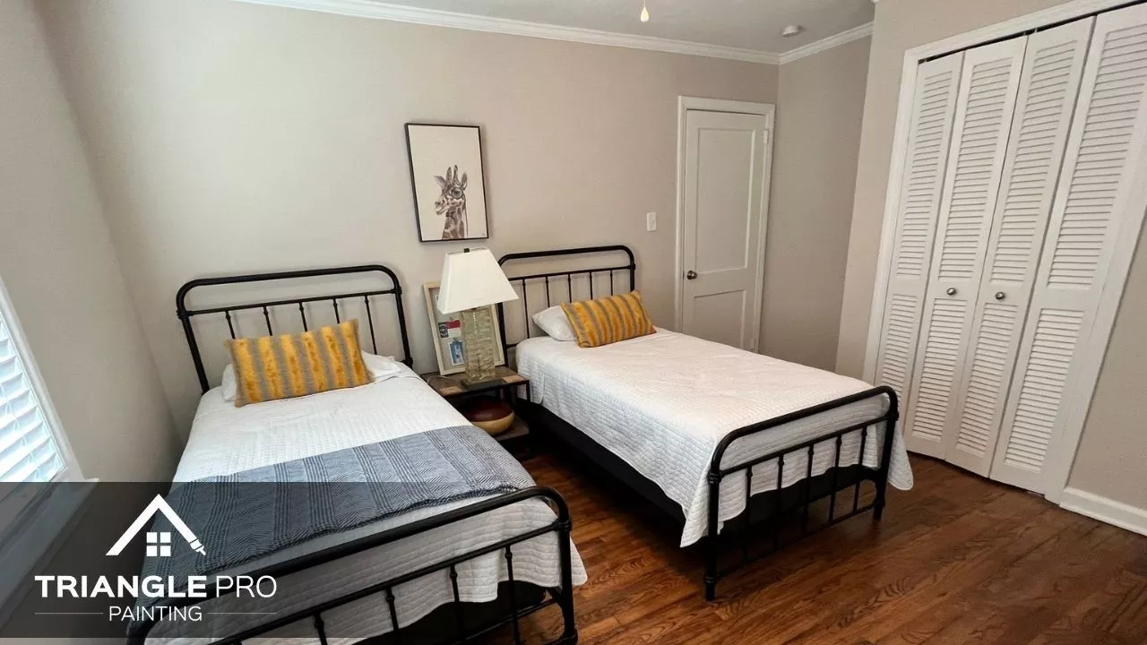 This is a freshly painted twin bedroom with soft beige walls by Triangle Pro Painting in Umstead Raleigh NC.