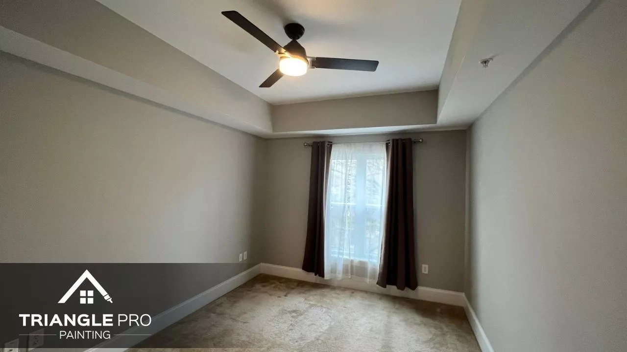 This is a repainted modern bedroom with natural lighting and neutral tones by Triangle Pro Painting in Umstead Raleigh NC.