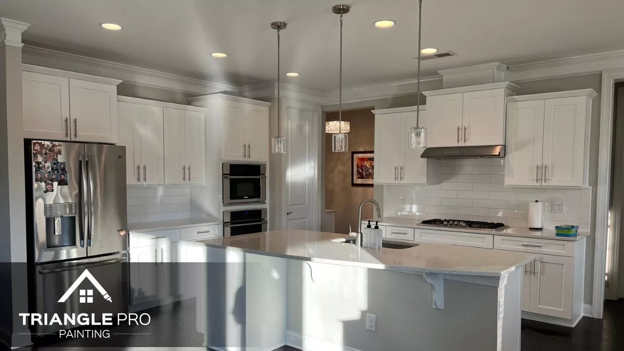 This is a freshly painted kitchen with white cabinets by Triangle Pro Painting in Wayland Heights Raleigh.