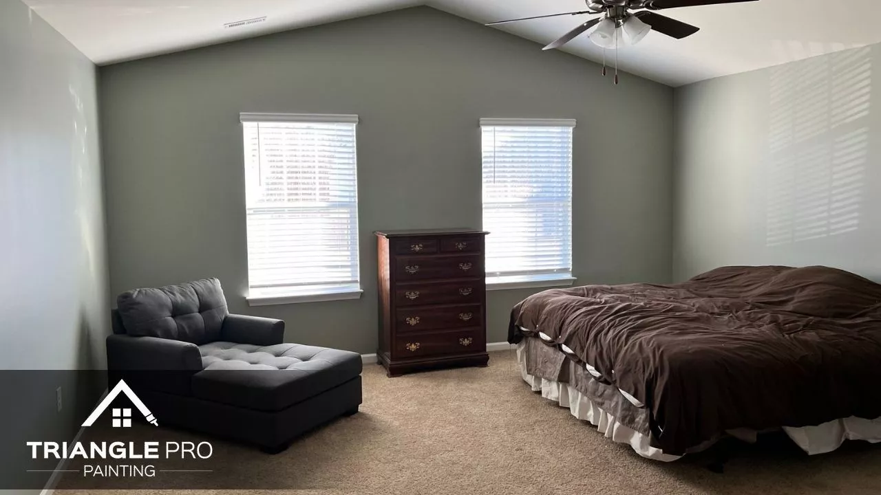 This is a cozy bedroom painted in sage green and tan tones by Triangle Pro Painting in Umstead Raleigh NC.