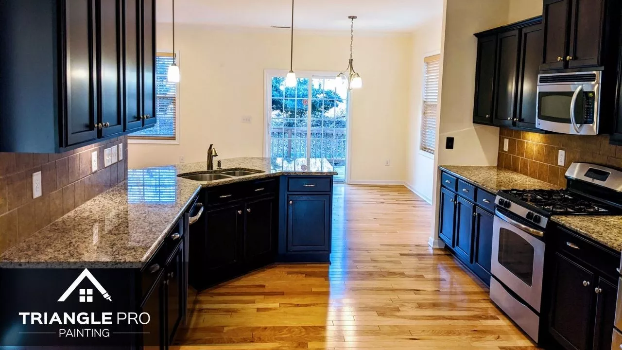 Interior painting and cabinet finish in a bright kitchen by Triangle Pro Painting in Wayland Heights Raleigh.