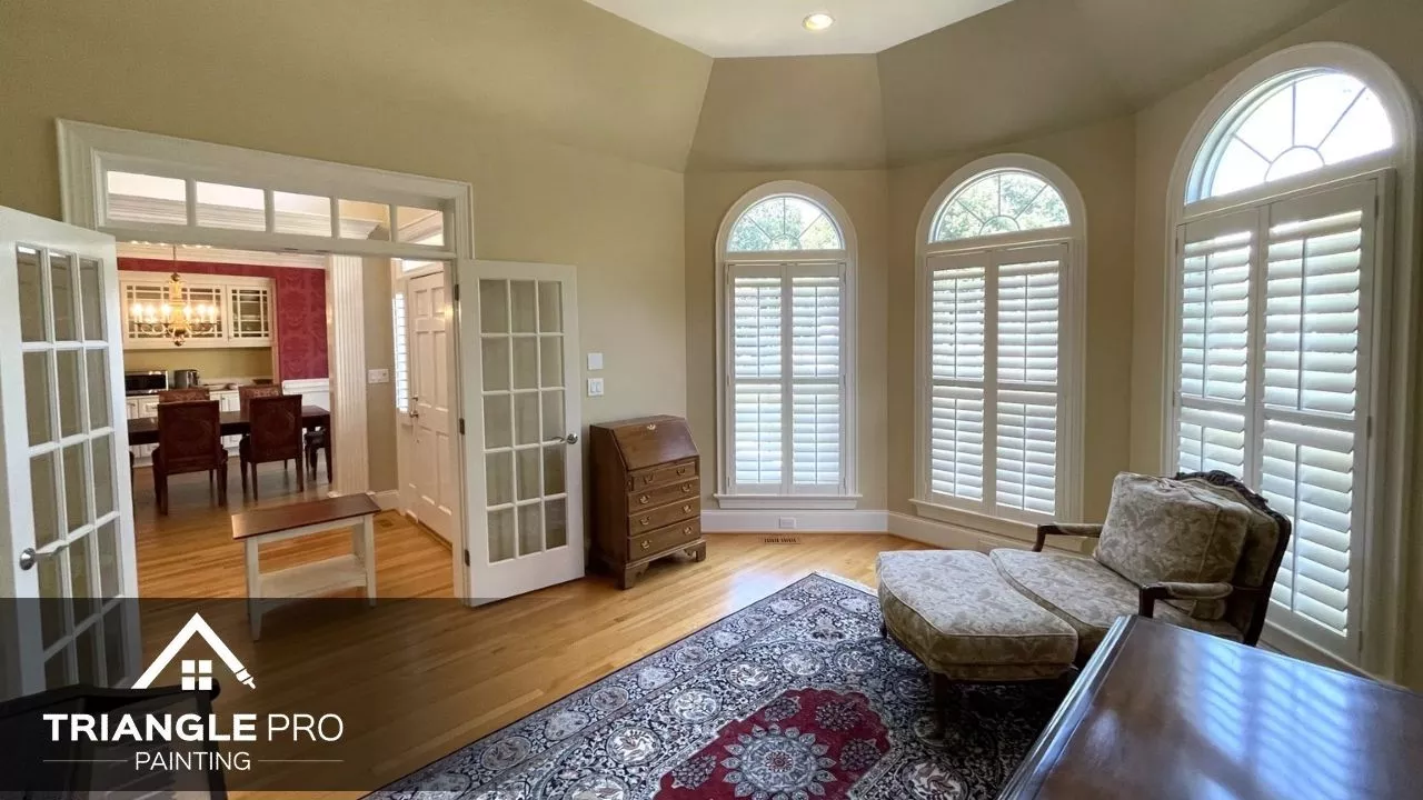Elegant neutral wall painting in a sunroom with arched windows by Triangle Pro Painting in Wayland Heights Raleigh.