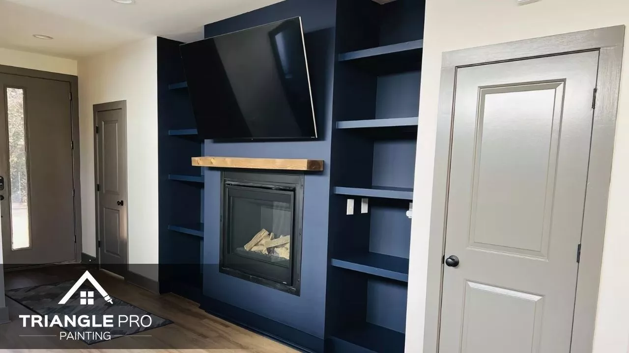 Triangle Pro Painting added bold navy built-ins and fireplace surround in this home in Wayland Heights Raleigh.