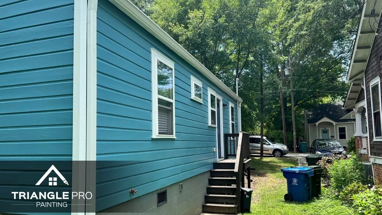 A bright blue home exterior freshly painted with white trim.