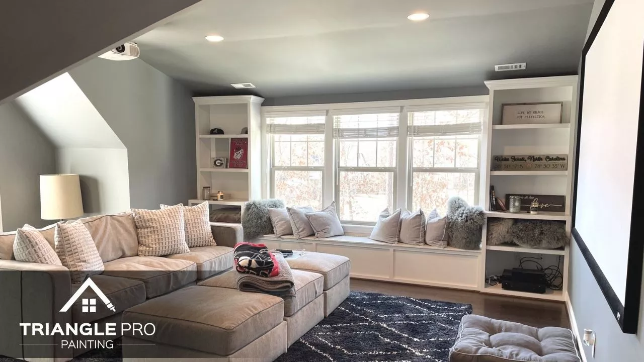A cozy living room with gray walls and white trim, painted for a warm, modern look.