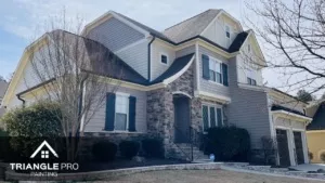 A two-story home with a sharp, freshly painted exterior featuring stone and siding details