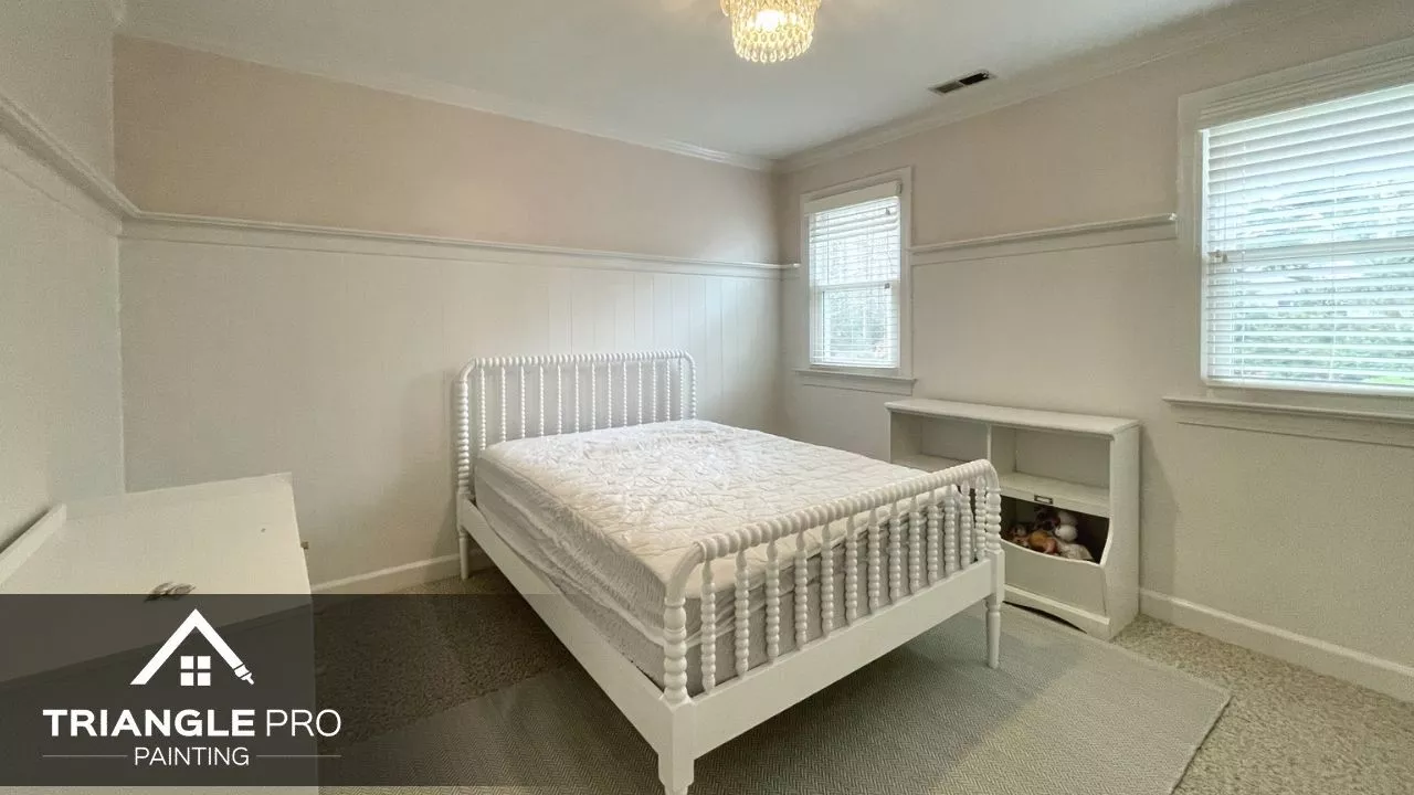 This image showcases a clean, modern bedroom interior painted in neutral tones by Triangle Pro Painting in Umstead Raleigh NC.