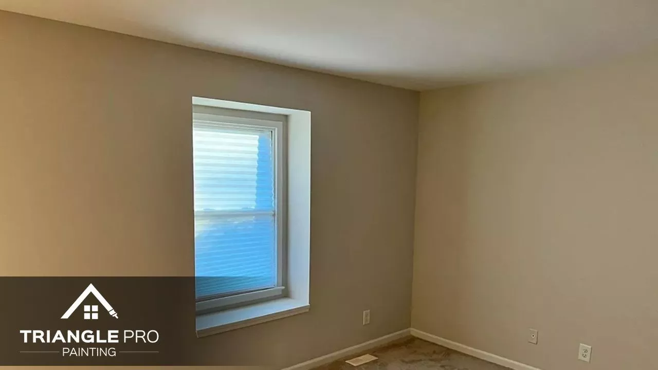This is a freshly painted beige bedroom by Triangle Pro Painting in Umstead Raleigh, NC.