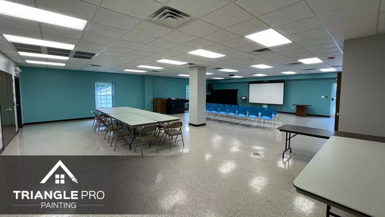 A commercial building in Raleigh, NC, that is painted with blue green paint.