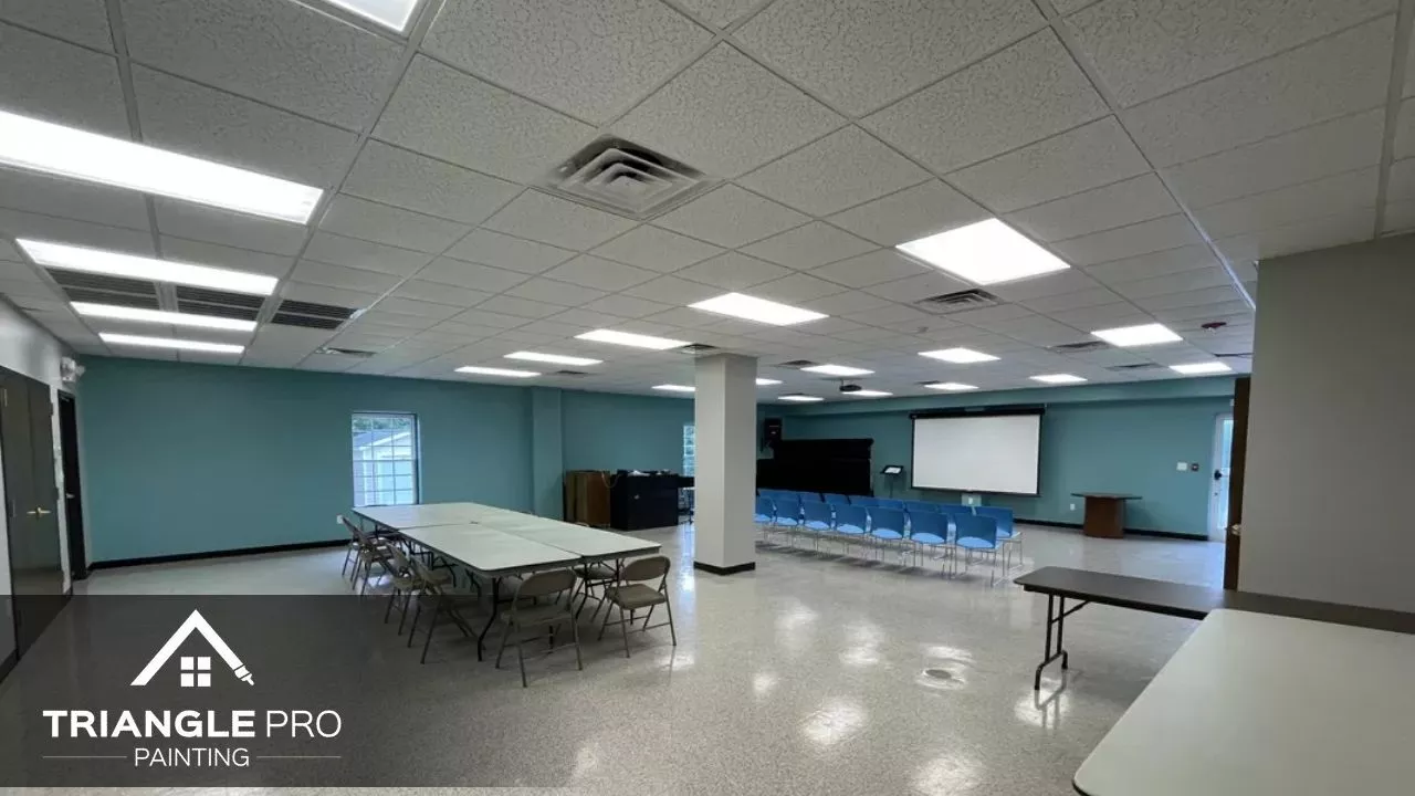 A spacious, freshly painted commercial interior by Triangle Pro Painting – ideal for meetings and events, with clean walls and bright lighting.