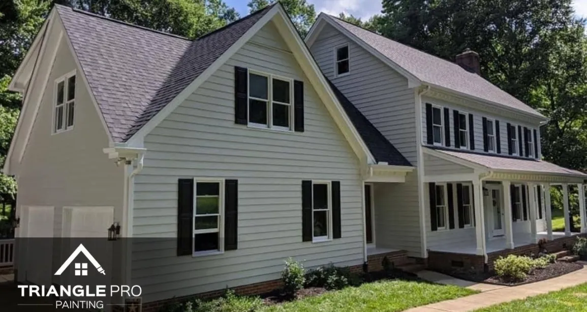 A beautiful exterior residential painting project by Triangle Pro Painting – fresh siding, dark shutters, and crisp white trim for standout curb appeal.