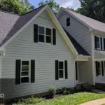 A beautiful exterior residential painting project by Triangle Pro Painting – fresh siding, dark shutters, and crisp white trim for standout curb appeal.