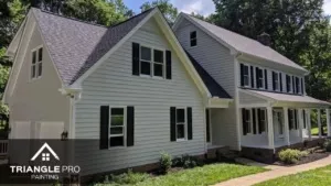 A beautiful exterior residential painting project by Triangle Pro Painting – fresh siding, dark shutters, and crisp white trim for standout curb appeal.