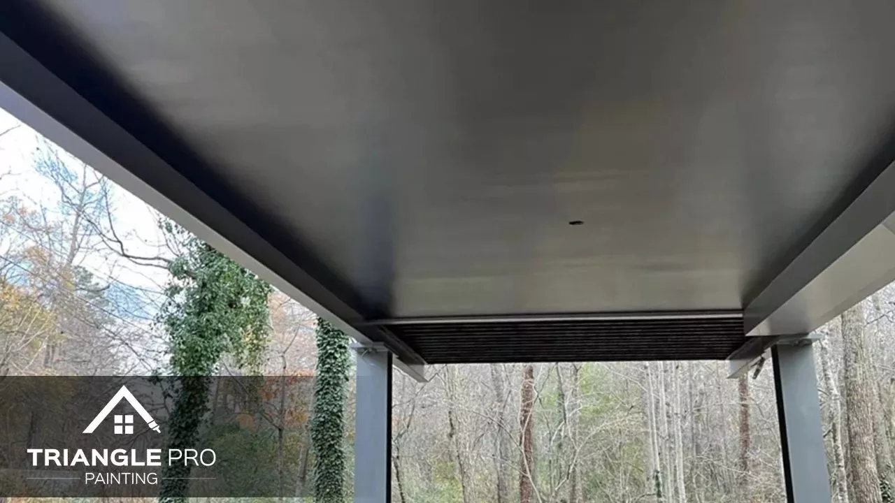 This photo highlights the smooth underside ceiling of a modern elevated home in Madonna Acres, painted by Triangle Pro Painting.