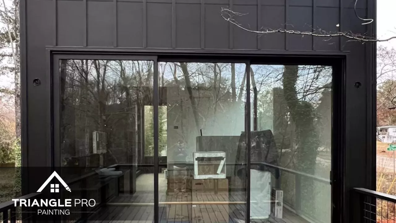 This image captures the large glass sliding door of a modern painted exterior in Madonna Acres by Triangle Pro Painting.