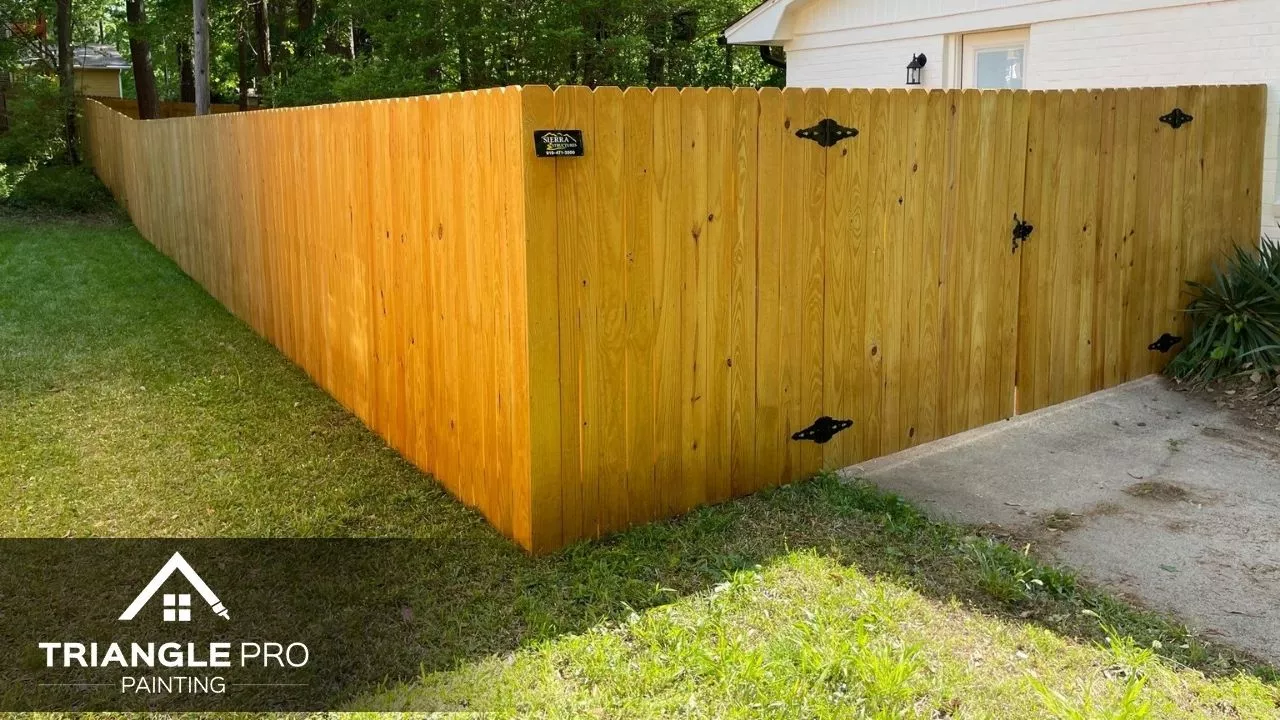 This image features a fresh fence staining project by Triangle Pro Painting in Boylan Heights, Raleigh NC.