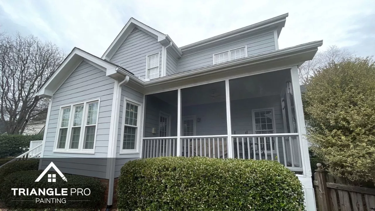 This is a completed exterior painting project featuring a two-story home with crisp gray siding and white trim by Triangle Pro Painting in Boylan Heights Raleigh, NC.