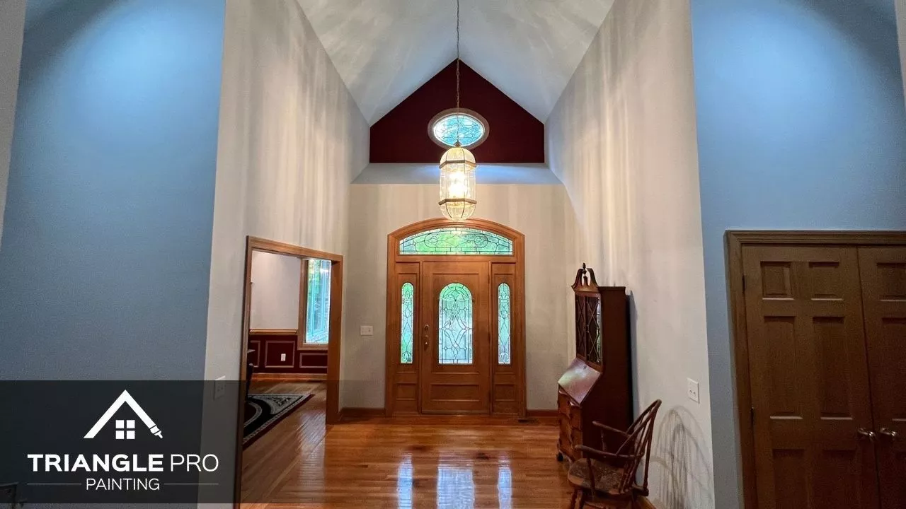 This is an entryway interior painting project with two-tone walls and wood trim by Triangle Pro Painting in Boylan Heights Raleigh.
