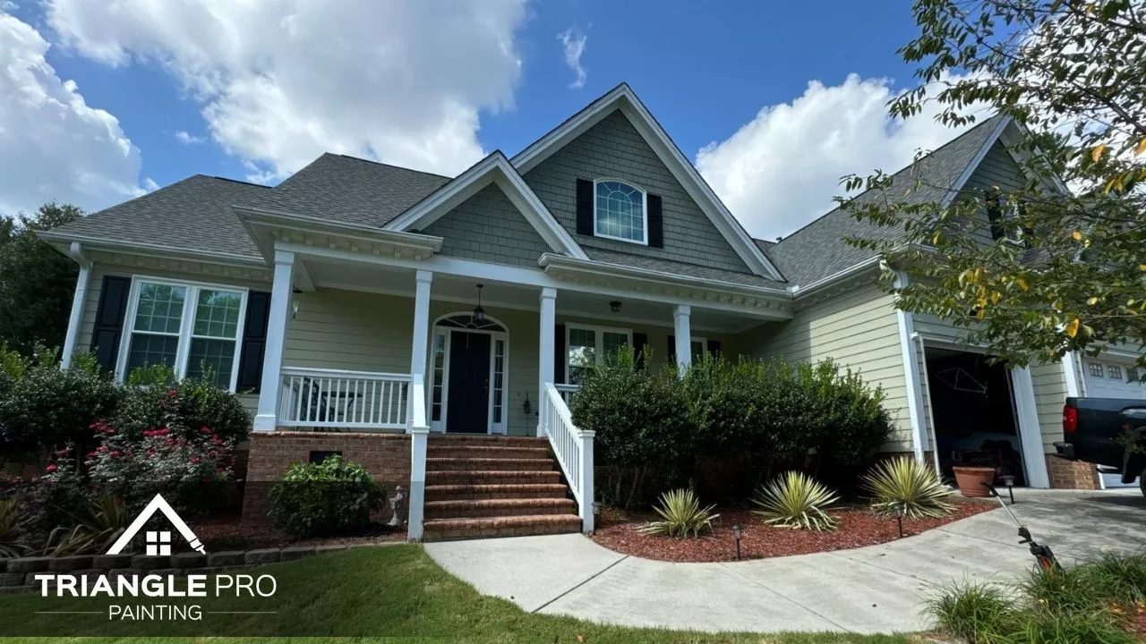 This is a front view of a house with freshly painted siding and trim, completed by Triangle Pro Painting in Boylan Heights Raleigh.