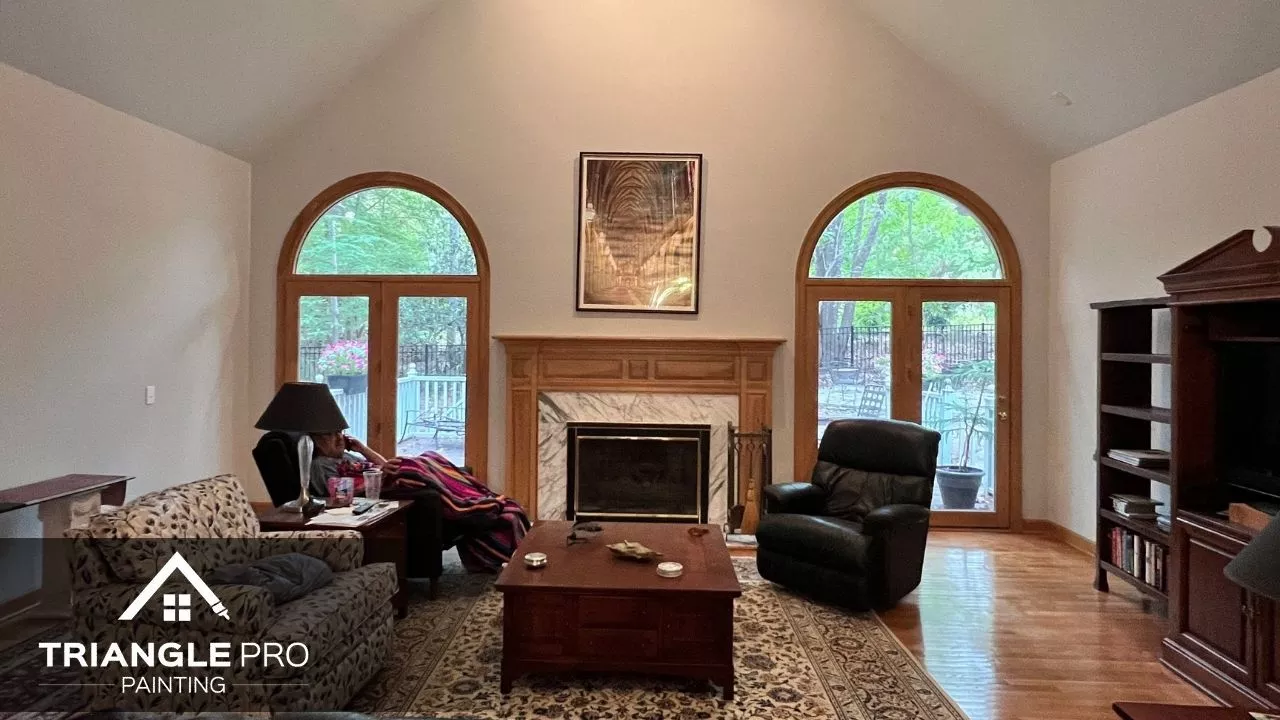 This is a living room interior painting project with vaulted ceilings and arched windows, done by Triangle Pro Painting in Boylan Heights Raleigh.