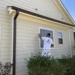 Painter preparing interior walls before applying new paint in a Raleigh home